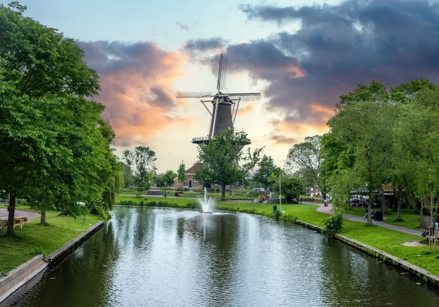 Windmill De Valk at sunset, tower mill and museum in Leiden city, Holland Netherlands.